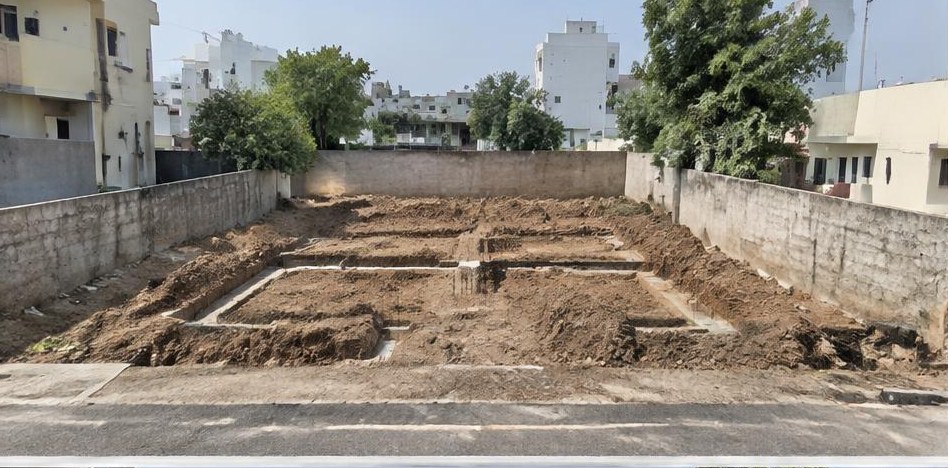 Illustrative before: Excavated foundation layout before structural work.