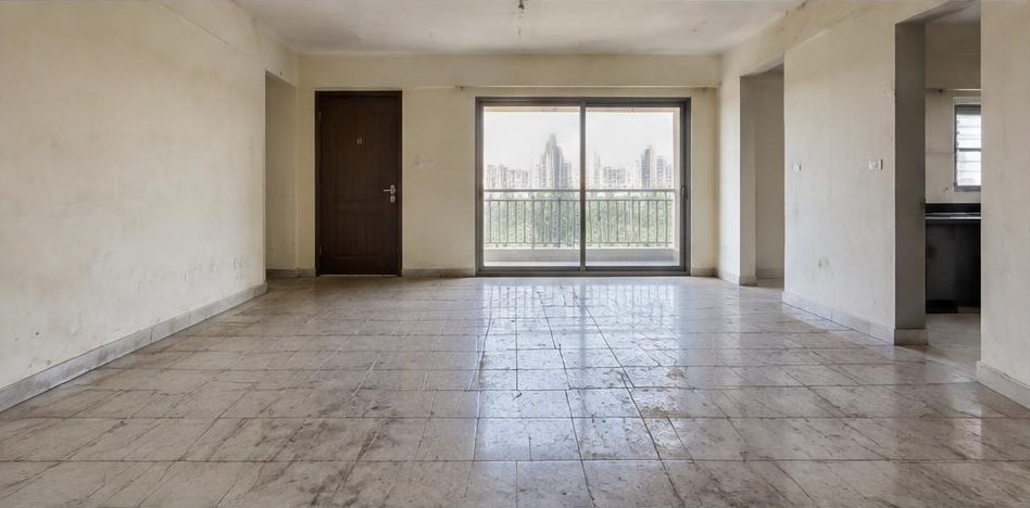 Illustrative before: Worn floor tiles before removal and base preparation.
