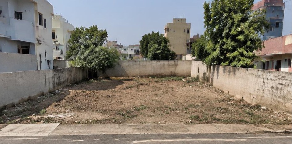 Illustrative before: Vacant plot before house construction.